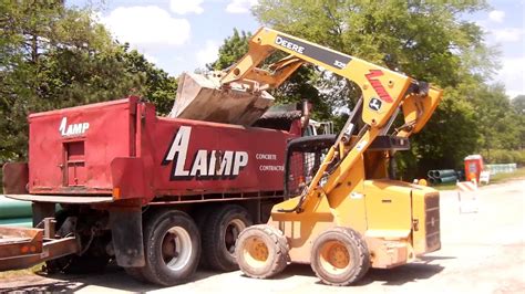 loading skid steer into dump truck|john deere dump trailer loading.